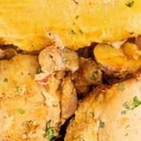 Tamal Con Pollo · Cuban style pork tamal served with tender chicken thighs simmered in a Fricassee wine sauce ...