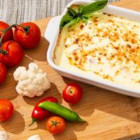 Baked Cauliflower · Baked cauliflower in garlic lemon sauce, topped with parmesan cheese. Comes with pita bread....