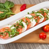 Caprese Salad · Sliced tomatoes, fresh Mozzarella cheese and fresh basil. Served with home-made Italian dres...