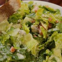 Caesar · Crisp romaine lettuce tossed with shredded parmesan, croutons and Caesar dressing.