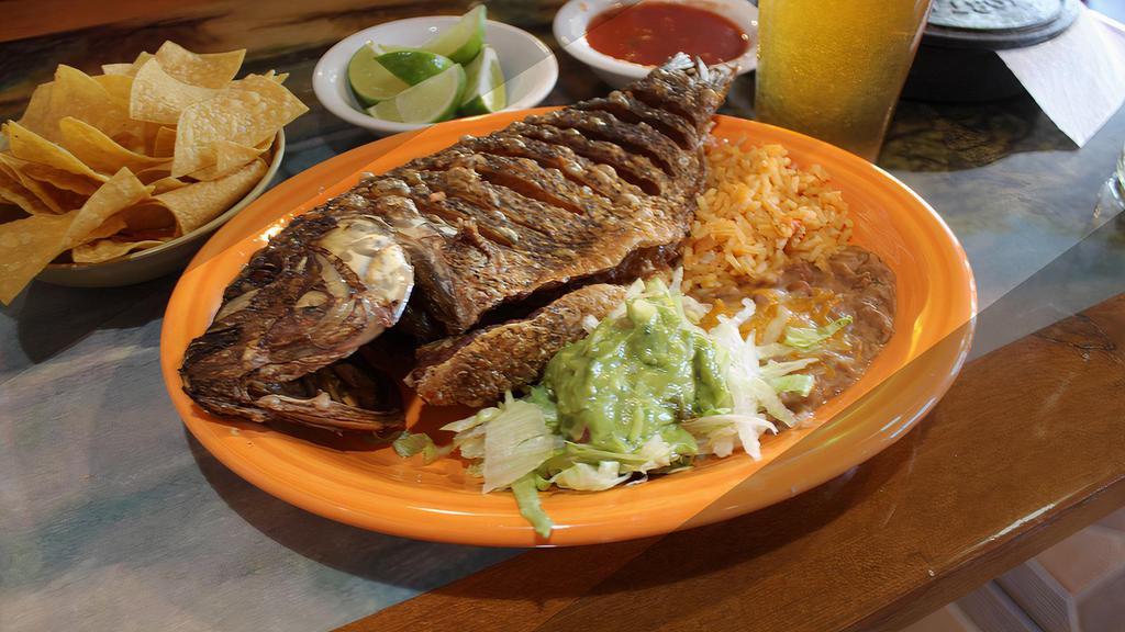 Mojarra Frita · Fried fish seasoned with our own seafood seasoning. served with rice, beans, and tortillas.