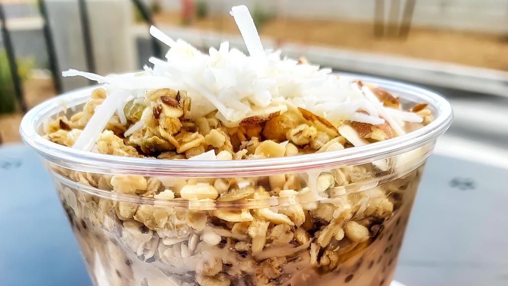Vegan Overknight Oats · Rolled oats, soy milk, peanut butter, chia seeds, vanilla, banana, shaved coconut, pumpkin flax granola, almonds, agave, chilled.