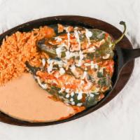 Chiles Rellenos (2) · 2 grilled poblano peppers, tomato sauce, with an order of tortillas (corn or flour) and rice...