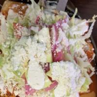 Enchiladas Del Suelo (4) · Soft corn tortillas covered in a red sauce made with chorizo topped with lettuce, onion, cot...