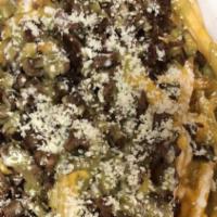 Carne Asada Fries · French fries covered in nacho cheese, guacamole, sour cream, and cotija cheese.