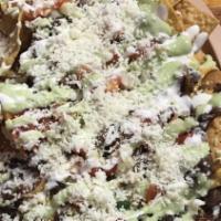 Nachos Supreme · Chips with pork refried beans and nacho cheese, cabbage, pico de gallo, guacamole, sour crea...