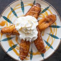 Fried Plantains · Fried ripe plantains topped whipped cream and drizzled with caramel.