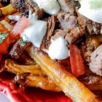 Carne Asada Fries · Grilled carne asada on top of seasoned fries, topped with melted cheese, pico and sour cream.