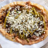 Huarache · One big corn tortilla with refried beans asada mexican cactus onions and mex cheese