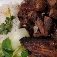 Roast Duck & Rice · Steamed rice with rotisserie duck. Served with bok choy, and fish sauce.