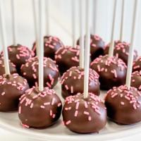 Chocolate Covered Strawberry Cake Pop · Strawberry cake dipped in chocolate and accented with pink sprinkles. Yum! All cake pops are...