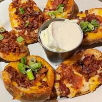 Potato Skins · Six Crispy Skins with Cheddar-Jack Cheese, crispy bacon, and green onions. . Served with sid...