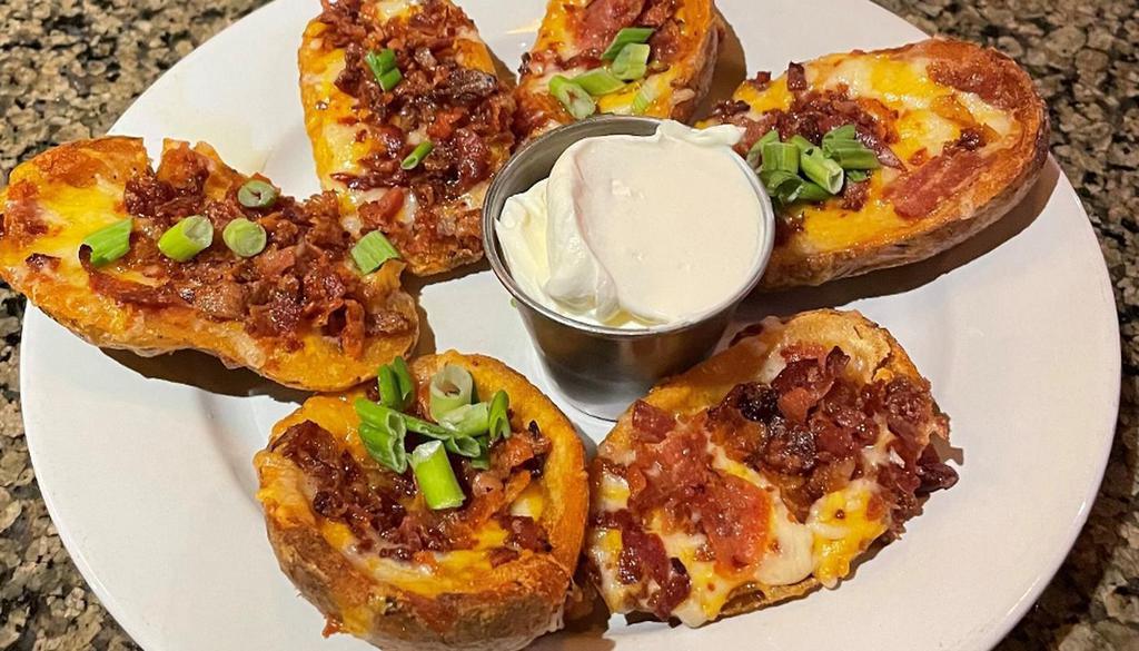 Potato Skins · Six Crispy Skins with Cheddar-Jack Cheese, crispy bacon, and green onions. . Served with side of Sour Cream