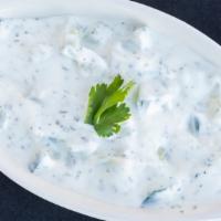 Mast O Khiar · Yogurt with chopped cucumber, mints and herbs.