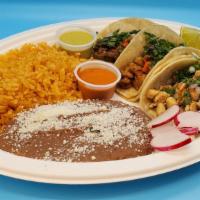 Taco Plate Asada · Three asada tacos with cilantro, onion, and sauce served with rice and beans.