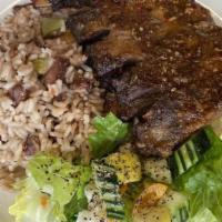 Jerk Ribs Meal · Jerk spiced pork spare ribs with fried rice and house salad.