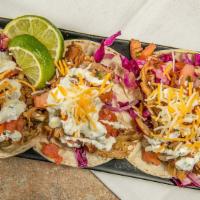 Smoked Street Tacos · Three corn tortillas filled with your choice of smoked chicken or pork. Served with Carolina...