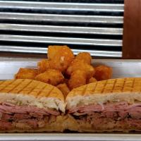 Cuban Panini · Smoked Pulled Pork topped with Ham, Swiss Cheese, Pickles and Spicy Mustard