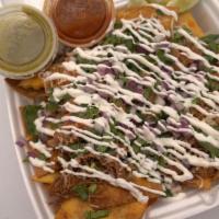 Taco Nachos · Tortilla Chips Loaded With Shredded Beef, Cheese, Consomé, Sour Cream, Guacamole, Cilantro, ...