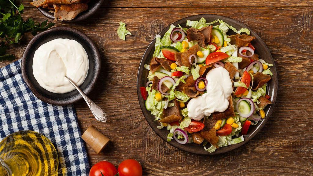 Gyro Salad · Yummy Mediterranean roasted gyro meat, lettuce, tomatoes, cucumbers, onions, olives, feta cheese topped with tzatziki sauce.