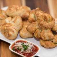 Garlic Knots · Strips of our famous pizza dough tied up in little knots, stuffed with fresh garlic, olive o...
