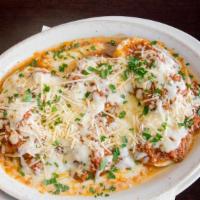 Baked Ravioli · Meat stuffed pasta covered with bolognese sauce, mozzarella and Parmesan. Served with garlic...
