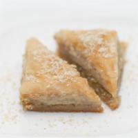 Baklava · Layers of flaky pastry sheets lightly brushed with butter and capped by a thick sweet syrup-...