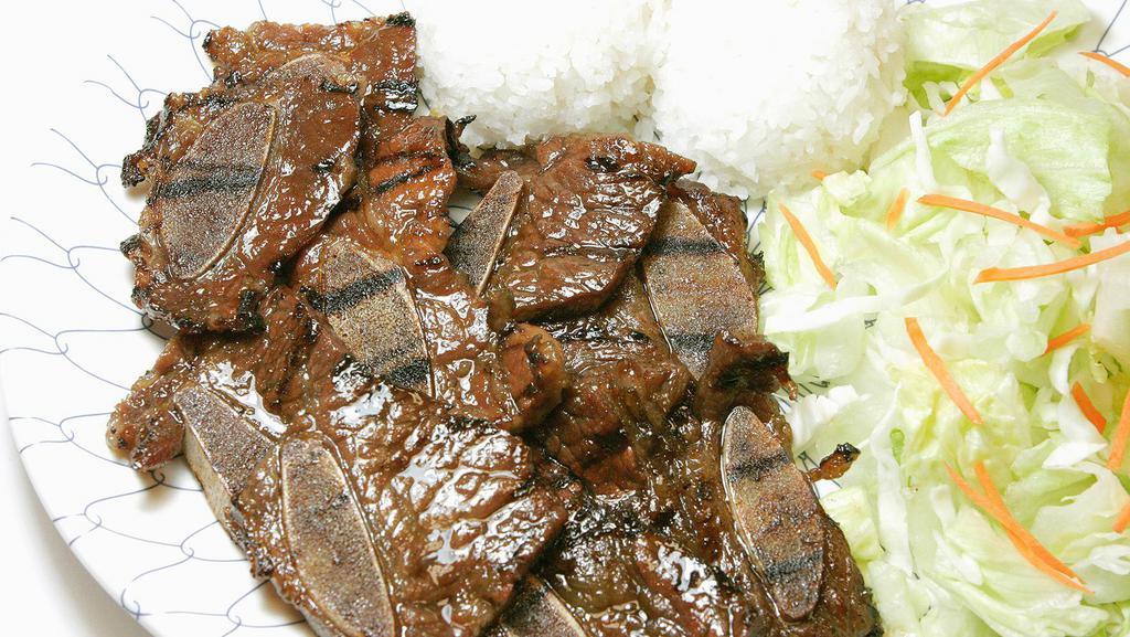Beef Short Ribs · Served with salad and rice.
