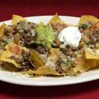 Meat Nachos · Our home made chips topped with your choice of meat,cheese,beans,sour cream,pico de gallo an...