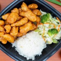 Orange Chicken · Orange chicken with a side of rice and steamed vegetables.