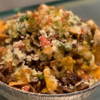 Loaded Nachos · Chicken, Asada or Al Pastor on top of yellow corn chips, nacho queso, cheddar cheese, pico d...