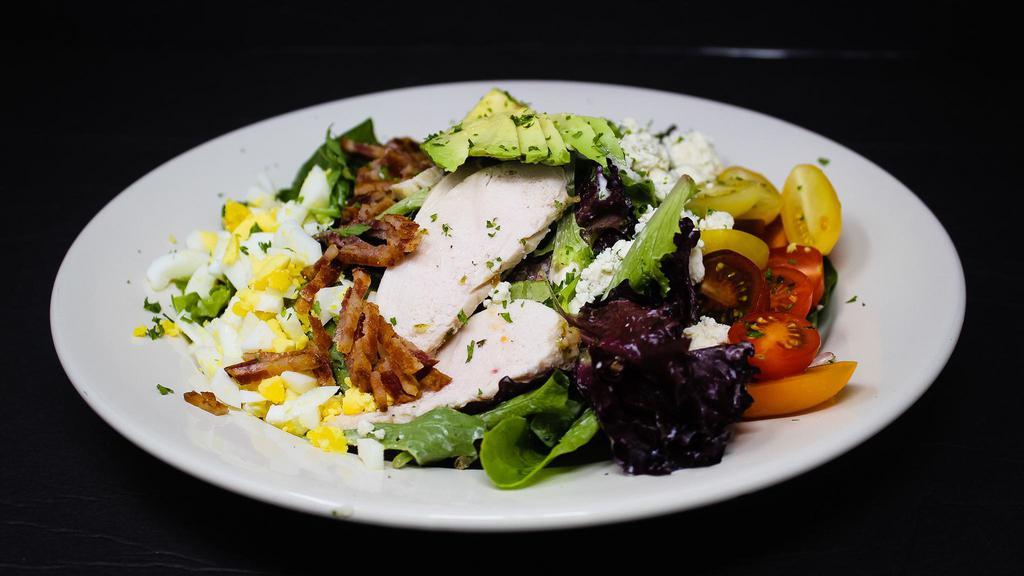 Chicken Cobb Salad · Chipotle-citrus-marinated chicken, mixed greens, avocado, fresh tomatoes, bacon, hard-boiled egg, blue cheese crumbles, blue cheese dressing.