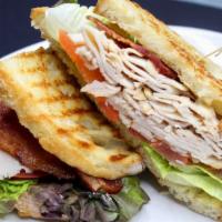 Turkey Club Sandwich · bacon, tomato, lettuce, Swiss cheese, garlic aioli.