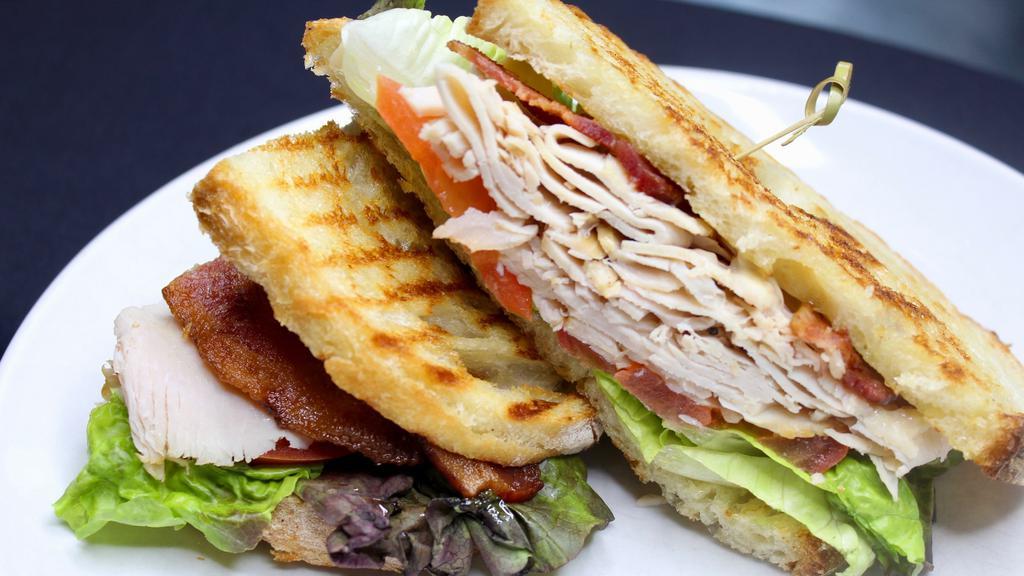 Turkey Club Sandwich · bacon, tomato, lettuce, Swiss cheese, garlic aioli.