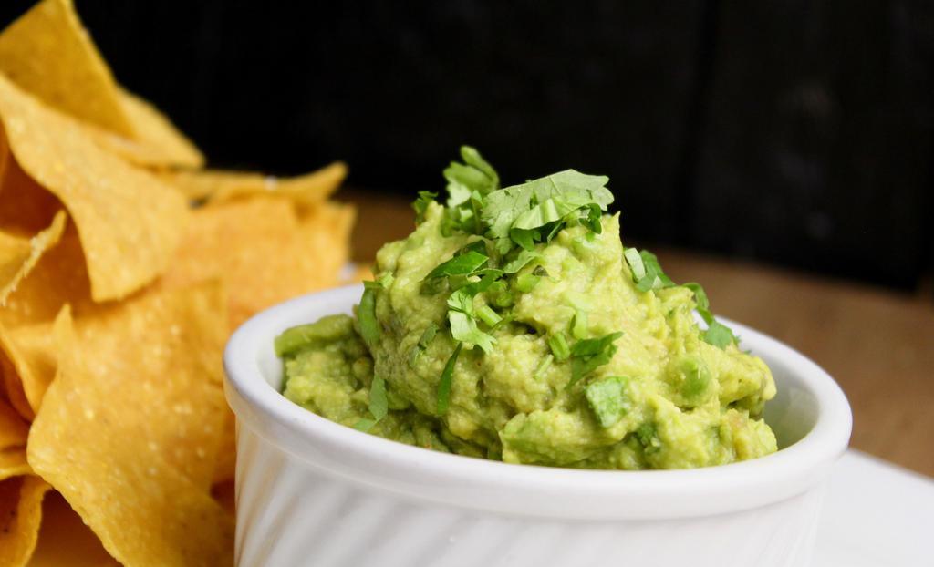 Guacamole · house made with avocado, lime, cilantro, house-made lime tortilla chips and salsa Choice of Salsa - roasted tomato / chipotle / spicy salsa verde / pineapple / avocado crema.