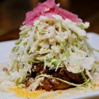 Yucatan Pork Taco · Cochinita pibil marinated in an achiote rub, cabbage, cotija and pickled onion slaw.