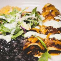 Vegetarian Enchilada · portobello, pablano, bell pepper and kale with black beans, cabbage slaw, chipotle crema, co...