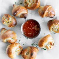 Garlic Knots (6 Pcs) · A classic snack, our garlic knots are strips of pizza dough tied in a knot, baked & then top...