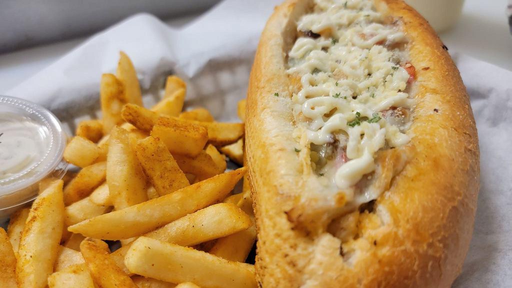 Chicken Philly Cheesesteak · Our amazing Philly recipe with a twist. Fresh cut mushrooms, bell pepper and onion sauteed with sliced chicken. Topped with mayo, provalone cheese and parmesean cheese.  Served with your choice of side