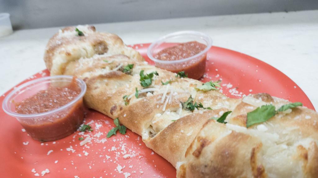 Meatball Stromboli · A  braided pizza filled with meatballs, mozzarella cheese and homemade marinara sauces baked to golden perfection. Half the size of our traditional stromboli