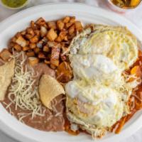 Chilaquiles · With egg cheese and sour cream. served with beans and potatoes.
