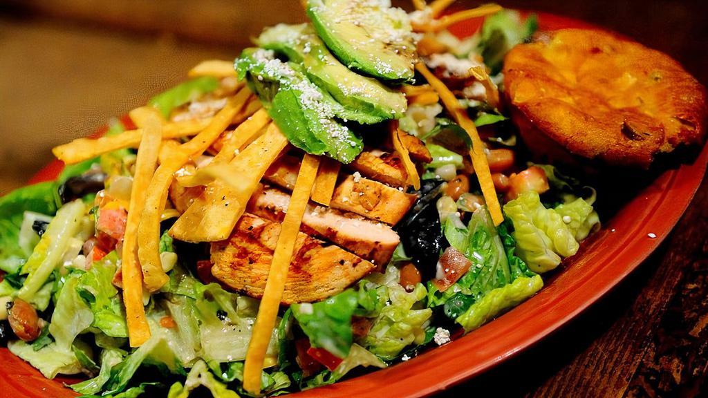 Mexican Chopped Salad · Chopped lettuce, tossed with pinto beans, tomatoes, green onions, black olives, corn, cilantro, cheddar, jack + your choice of dressing, topped with grilled chicken, quest fresco, avocado, tortilla strips + jalapeño corn muffin.