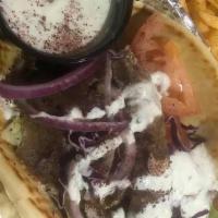 Traditional Gyro W/ Fries · Traditional Gyro with your choice of meat, sauce and topped with lettuce, onions, and tomato...