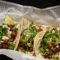Al Carbón (Regular)Tacos · (3) tacos large corn tortilla,Chopped grilled steak cooked with pico de gallo.served with gu...