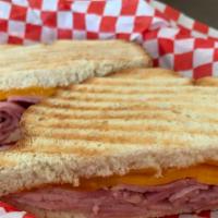 Grilled Ham And Cheddar Cheese · Farmhouse Smoked Ham and cheddar cheese.  Served on grilled sliced French bread.
