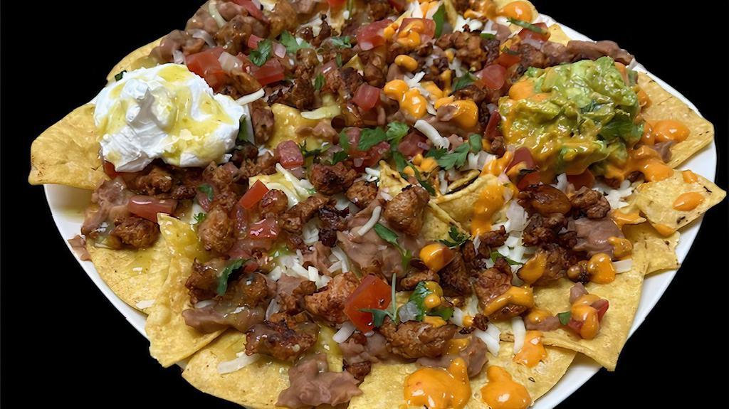 Pancho Nachos · Deep fried Corn Tortilla chips covered with delicious refried Beans , Cheese, Pico de Gallo and choice of Meat