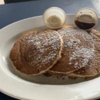 Original Sweet Cream Pancakes · Three fluffy homemade sweet cream pancakes topped with powdered sugar and served with maple ...