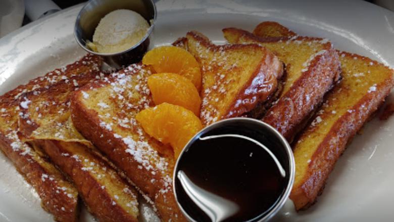 Traditional Cinnamon French Toast · 3 slices of Texas toast dipped in our homemade French toast batter, cooked to perfection, topped with powdered sugar, and served with maple syrup and sweet butter.