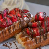 Liege Waffles With Strawberries And A Drizzle Of Guittard Bittersweet Chocolate · With vanilla infused whipped cream.