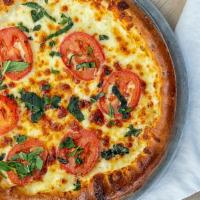 Margherita Pizza (Small) · Brushed with olive oil, fresh garlic, tomatoes, fresh basil, and mozzarella.